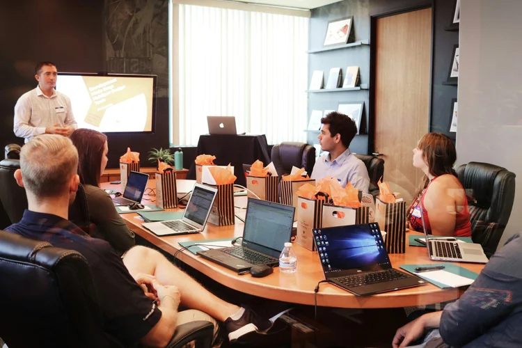 Consultants collaborating around a laptop